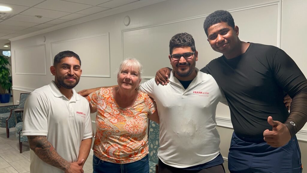 Frank & Sons moving crew standing with a customer after a move