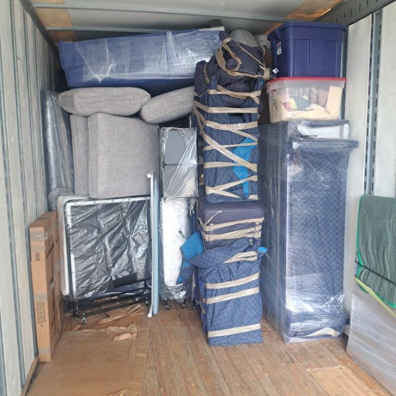 Frank and Sons packing crew wrapping and boxing household items in a Southwest Florida home